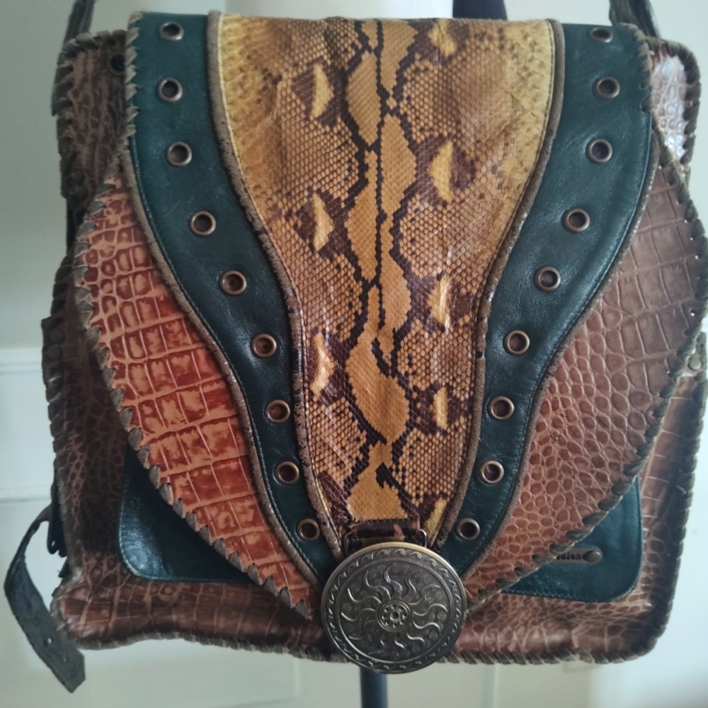 Unique, one of a kind, leather and snake skin messenger bag by Novi Sudiono.